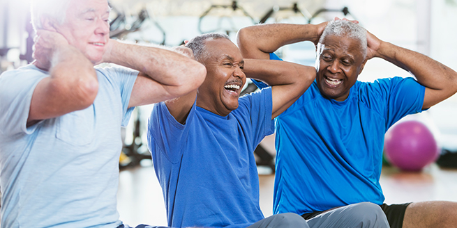 Active adults participating in senior fitness classes with resistance bands in a bright community gym