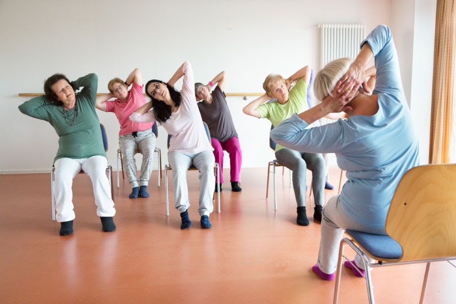chair yoga for seniors chair setup showing a sturdy non-rolling chair with feet flat and simple props nearby