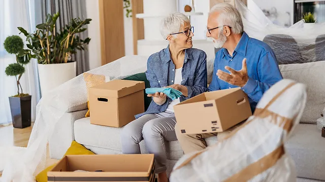 Independent senior living move in day with a senior settling into a new apartment and unpacking calmly